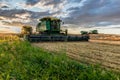 Swift Current, SK/Canada- Aug 25, 2019: Sunburst over combines and grain cart during harvest