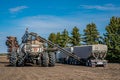 Swift Current, SK/Canada- May 15, 2020: Farmers loading seed and fertilizer from the Super B into Bourgault air drill for seed Royalty Free Stock Photo