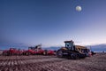 Swift Current, SK/Canada- 10 May, 2019: Full moon over Caterpillar tractor and Bourgault air drill in the field Royalty Free Stock Photo