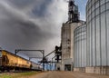 Swift Current, SK/Canada- 10 May, 2019: Semi unloading with stormy skies at Paterson Grain Terminal in Swift Current, SK, Canada