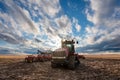 Swift Current, SK/Canada- May 9, 2020: Vast sunset sky over Case tractor and Bourgault seeding equipment Royalty Free Stock Photo