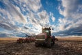 Swift Current, SK/Canada- May 9, 2020: Vast sunset sky over a farmer checking his Case tractor and Bourgault air drill Royalty Free Stock Photo
