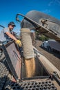 Swift Current, SK/Canada- May 15, 2020: Young farmer loading wheat seed from Super B into the Bourgault air drill for seeding Royalty Free Stock Photo