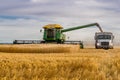 Swift Current, SK, Canada- Sept 8, 2019: Combine unloading wheat into grain truck