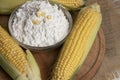 Swigs of raw corn on a burlap napkin and cornstarch in a glass dish. Fresh