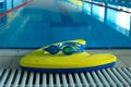 Swim board with Goggles on beside of the swimming pool in sports center. swimming training concept. copy space for text. Royalty Free Stock Photo