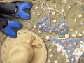 Swim fins, bikini set and straw hat on beach sand Royalty Free Stock Photo