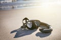 Swim flippers with snorkel, mask and feet steps on a sandy beach. Water sports. Snorkeling. Travel and holiday concept. Fins and s Royalty Free Stock Photo