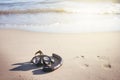 Swim flippers with snorkel, mask and feet steps on a sandy beach. Water sports. Snorkeling. Travel and holiday concept. Fins and s Royalty Free Stock Photo