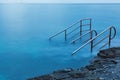 Swim ladder leading to mystic sea Royalty Free Stock Photo