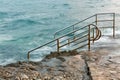 Swim ladder leading to stormy mystic sea Royalty Free Stock Photo