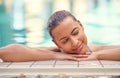 Swim your worries away. a young woman relaxing in the pool at a spa.