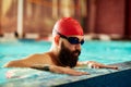 Swimmer athlete man resting at the side of the pool taking a break during training swims, swimming in the pool, training Royalty Free Stock Photo