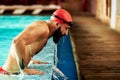 Swimmer athlete man resting at the side of the pool taking a break during training swims, swimming in the pool, training Royalty Free Stock Photo