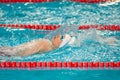 Swimmer boy swims backstroke swimming style in the pool Royalty Free Stock Photo
