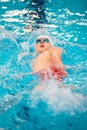 Swimmer boy swims backstroke swimming style in the pool Royalty Free Stock Photo