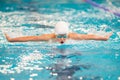 Swimmer boy swims butterfly swimming style in the pool Royalty Free Stock Photo