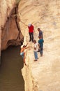 A swimmer climbs up in a narrow gorge in northern Sahara, Tunisia, Northern Africa