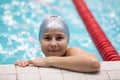 Swimmer girl holding board in swimming pool, young sportsman on the workout