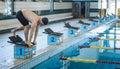 Swimmer jumping off the starting block Royalty Free Stock Photo