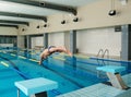 Swimmer jumping from starting block Royalty Free Stock Photo