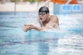 Swimmer performing the breaststroke in sport pool