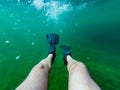 Swimmer's legs in black fins, underwater photo Royalty Free Stock Photo