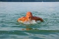 Swimmer, Senior man swimming butterfly strokes. Caucasian male aged 60 years Royalty Free Stock Photo