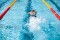 Swimmer splash after diving in the pool during contest Royalty Free Stock Photo