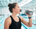 Swimmer, sports or woman drinking water to relax on break after exercise, workout or fitness training. Hydrate, thinking