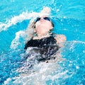 Swimmer in swim meet doing backstroke Royalty Free Stock Photo