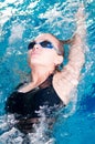 Swimmer in swim meet doing backstroke Royalty Free Stock Photo