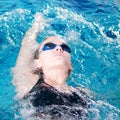 Swimmer in swim meet doing backstroke Royalty Free Stock Photo