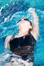 Swimmer in swim meet doing backstroke Royalty Free Stock Photo