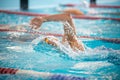 Swimmer swims freestyle swimming style in the pool Royalty Free Stock Photo