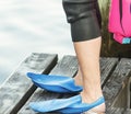 Swimmers feet with blue flippers on pier Royalty Free Stock Photo