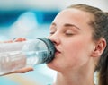 Swimmer woman, drinking water bottle or thinking for fitness, health or wellness for sport career. Athlete girl