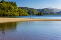 Swimmers in a calm lake surrounded by mountains on a hot summers day Royalty Free Stock Photo