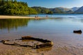 Swimmers in a calm lake surrounded by mountains on a hot summers day Royalty Free Stock Photo