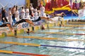 Swimmers diving into swimming pool