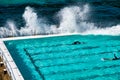 Swimmers enjoying beautiful pool at ocean border