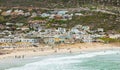 Swimmers frolicking in the shallow waves of Glencairn beach Royalty Free Stock Photo