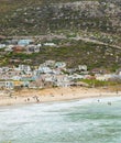 Swimmers frolicking in the shallow waves of Glencairn beach Royalty Free Stock Photo