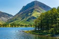 Swimmers on a large, calm lake surrounded by mountains on a hot summers day Royalty Free Stock Photo