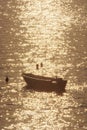 Swimmers and motor boat, sunrise in Mediterranean Sea, Solta, Croatia Royalty Free Stock Photo