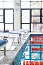 Swimmers preparing to dive into swimming pool, focusing on their start, copy space