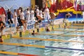 Swimmers starting diving into the swimming pool