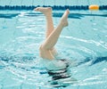 Swimming, athlete and legs in water upside down, exercise and training for healthy body. Pool, feet and person alone in