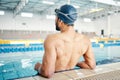 Swimming cap, pool and back of a man preparing for competition, exercise or training in a pool. Sports, fitness and Royalty Free Stock Photo