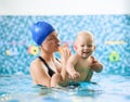 Mother with baby boy in swimming pool training Royalty Free Stock Photo